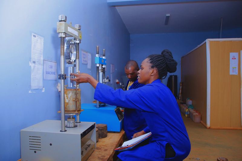 Tectoni laboratory technician operating a triaxial test rig